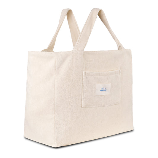 Off-white reversible organic cotton terry beach bag by Little Mariner with front patch pocket and branded label.