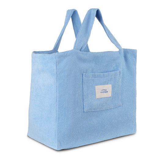 Coastal blue reversible organic cotton terry beach bag by Little Mariner with front patch pocket and branded label.