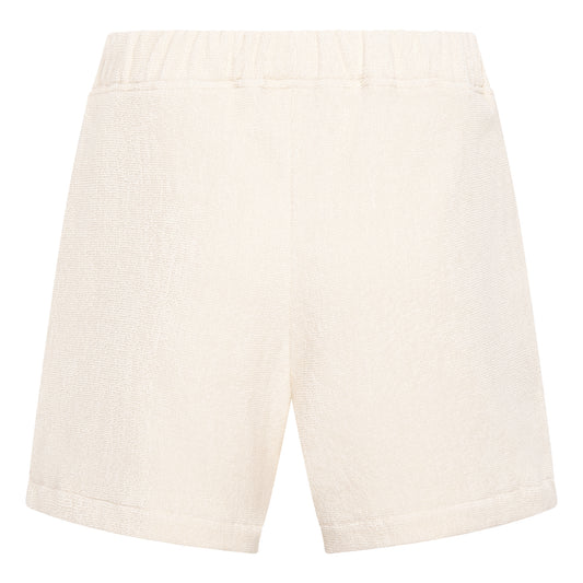 Off-white organic cotton terry relaxed fit shorts by Little Mariner with elastic waistband.