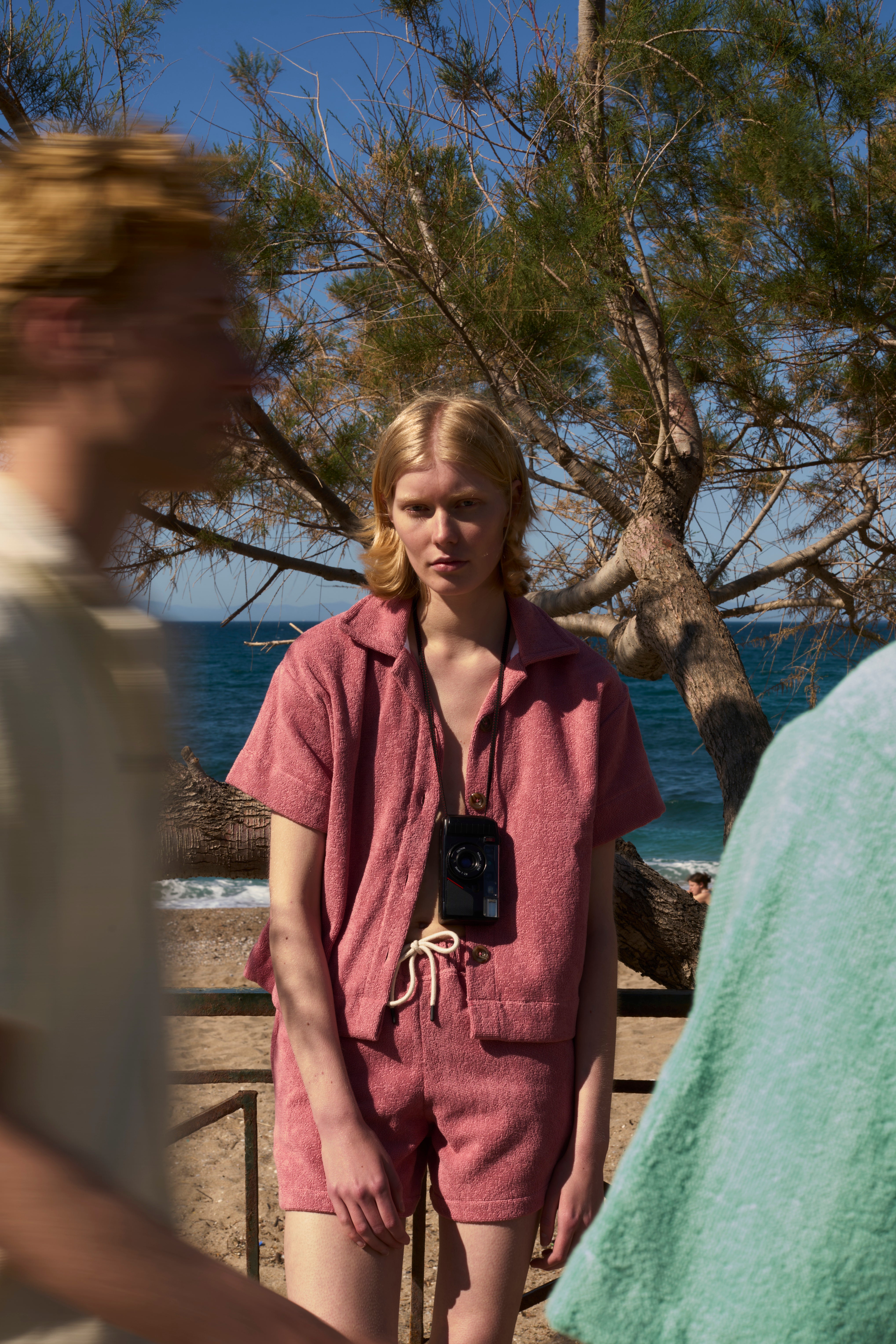 Woman in a Dusty Rose organic cotton terry shirt and matching shorts on a beach