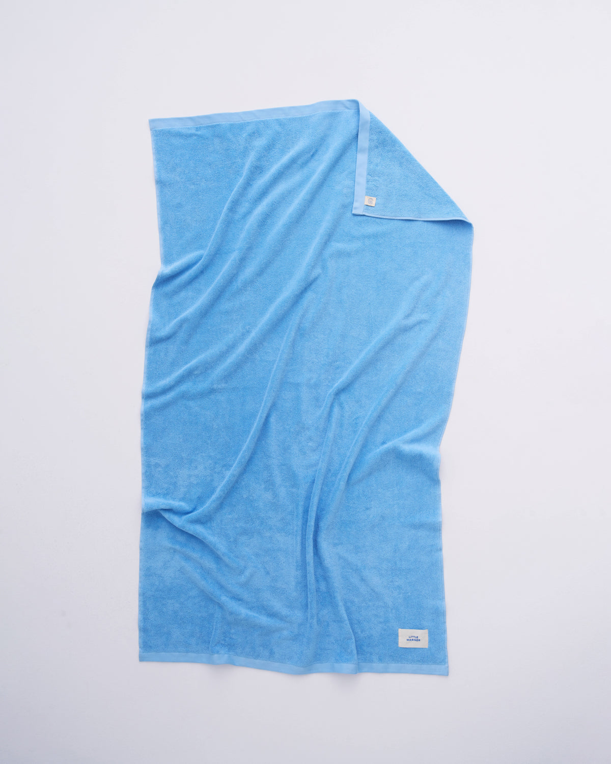 Coastal Blue organic cotton terry towel spread flat showing its full size
