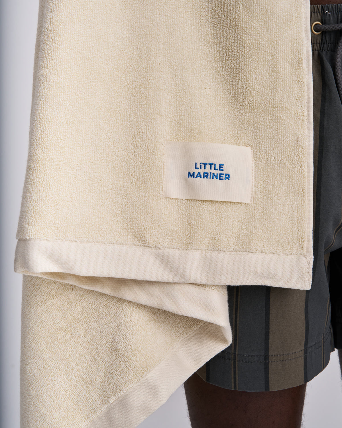 Close-up of an Off-White terry towel with its woven label and folded edge