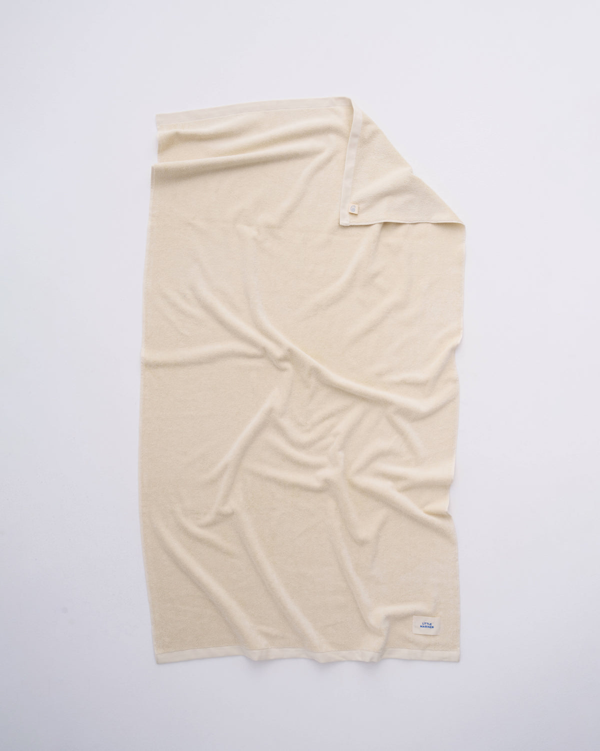 Off-White organic cotton terry towel spread flat showing its full size