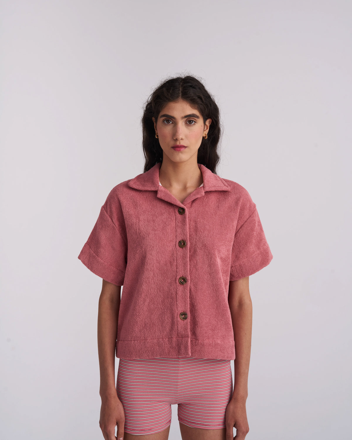 Woman wearing a Sage Green organic cotton terry camp-collar shirt, front view