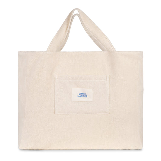 Off-white reversible organic cotton terry beach bag by Little Mariner with front patch pocket and branded label.
