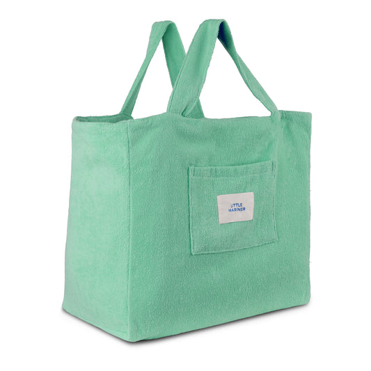 Sage green reversible organic cotton terry beach bag by Little Mariner with front patch pocket and branded label.