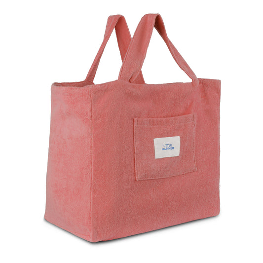 Dusty rose reversible organic cotton terry beach bag by Little Mariner with front patch pocket and branded label.