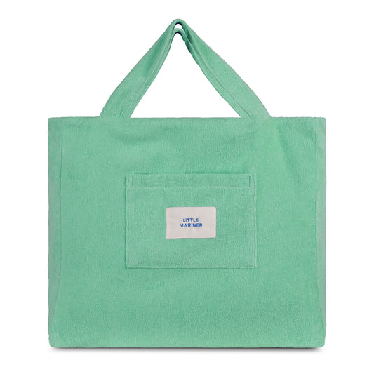 Sage green reversible organic cotton terry beach bag by Little Mariner with front patch pocket and branded label.