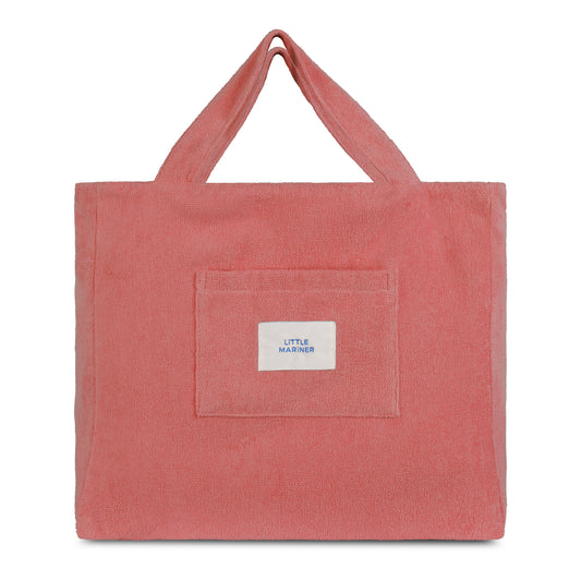 Dusty rose reversible organic cotton terry beach bag by Little Mariner with front patch pocket and branded label.