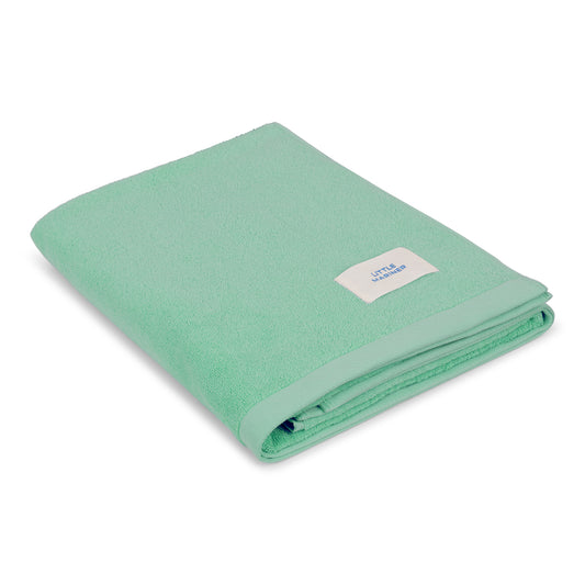 Folded sage green premium organic cotton terry towel by Little Mariner with branded label.