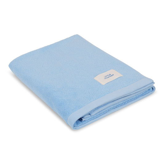 Folded coastal blue premium organic cotton terry towel by Little Mariner with branded label.