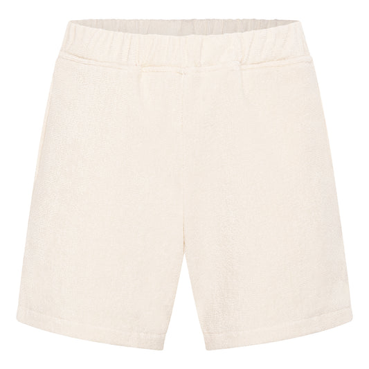 Off-white organic cotton terry relaxed fit shorts by Little Mariner with elastic waistband.
