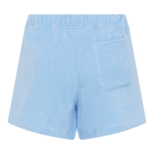 #Coastal Blue Back view of women’s coastal blue organic cotton terry relaxed fit shorts by Little Mariner with elastic waistband and patch pocket.