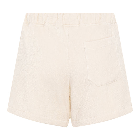 #Off-White Back view of women’s off-white organic cotton terry relaxed fit shorts by Little Mariner with elastic waistband and patch pocket.