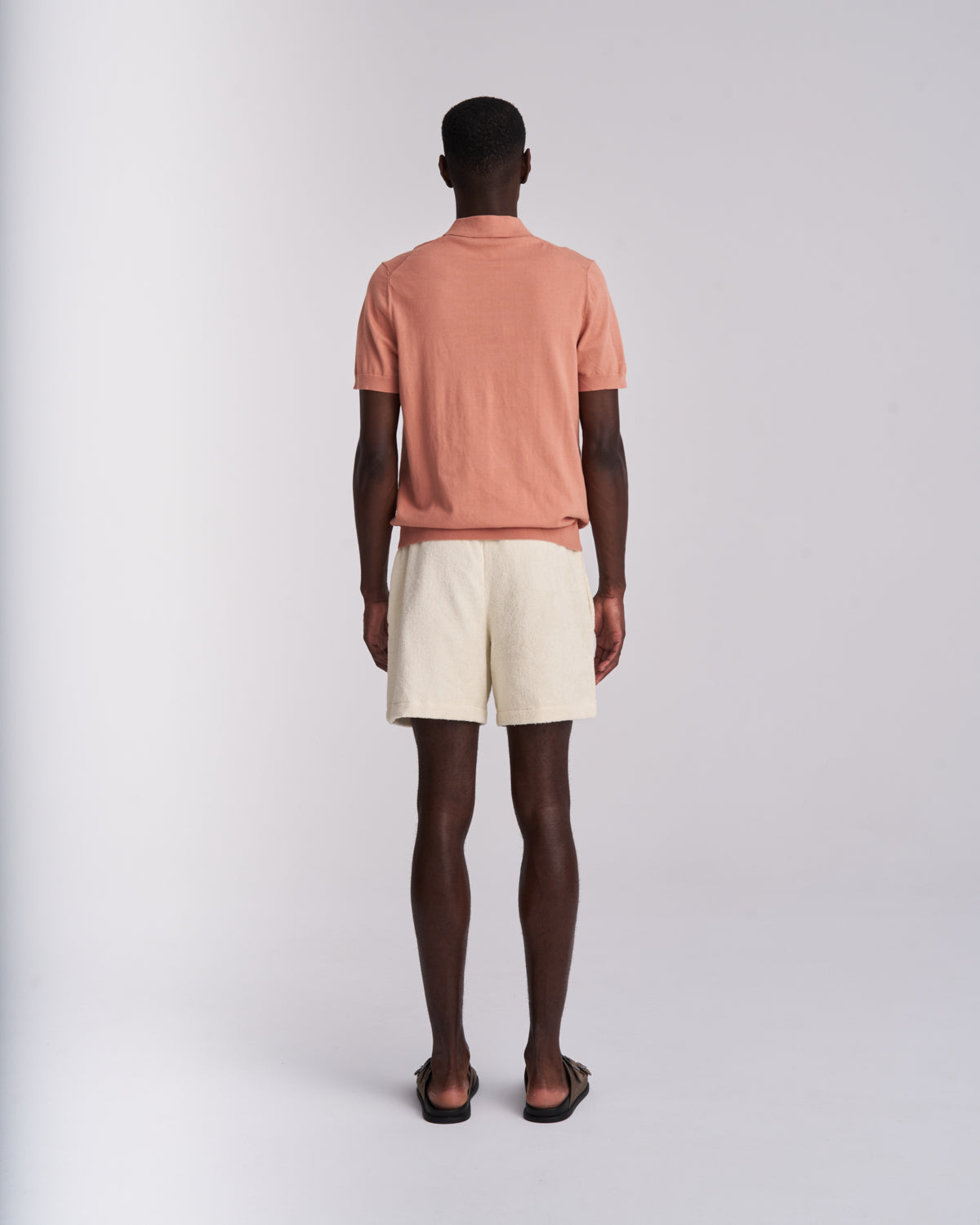 Man wearing Off-White organic cotton terry shorts with elasticated waist, back view on a plain background