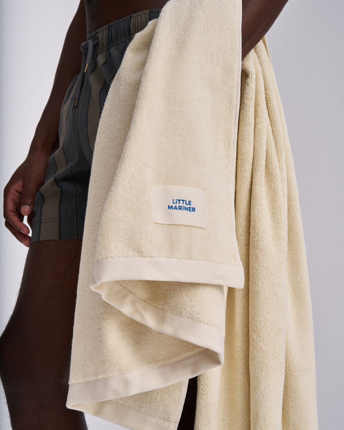 Off-White organic cotton terry towel carried over the arm, woven label showing
