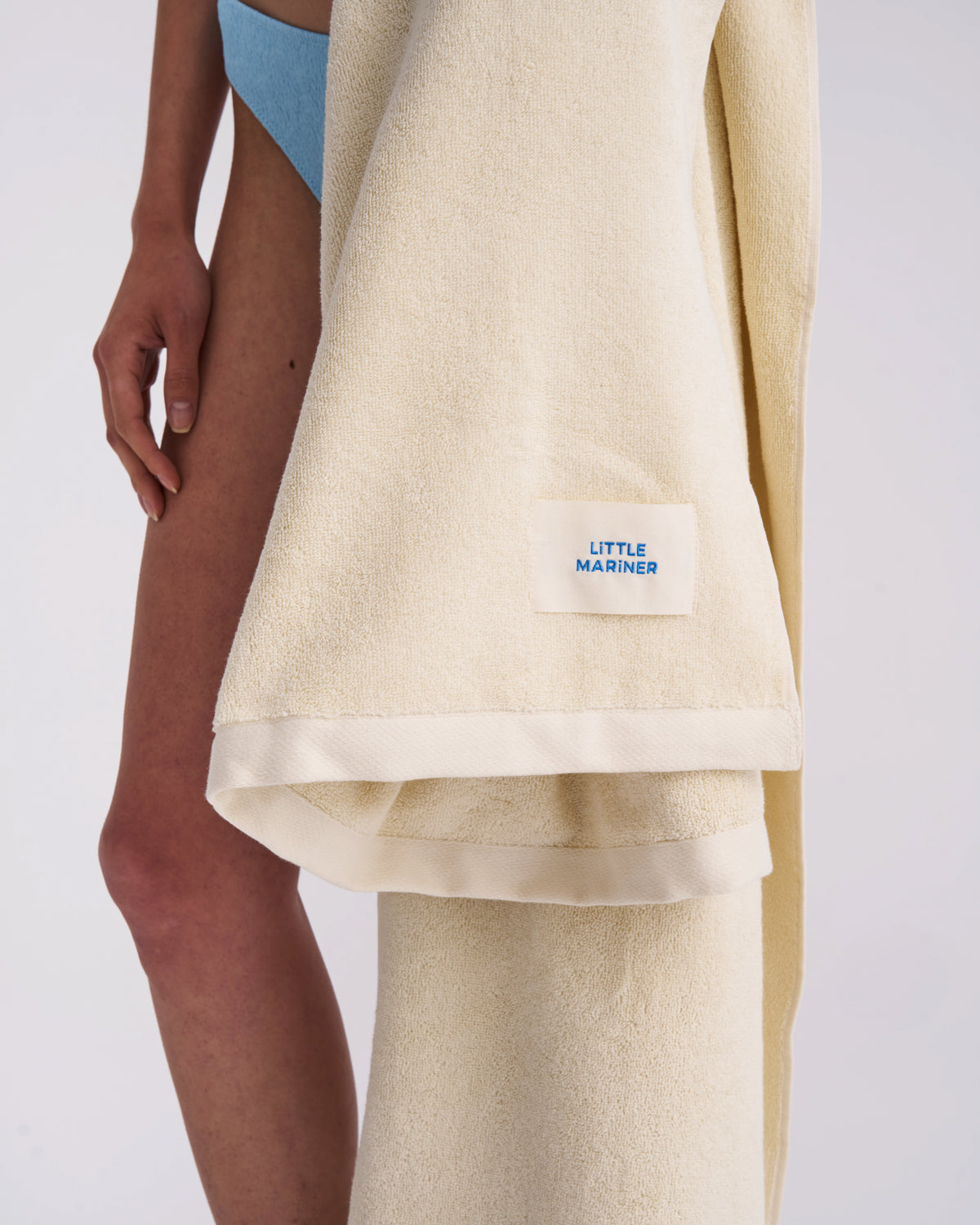 Off-White organic cotton terry towel draped at the side with its woven label