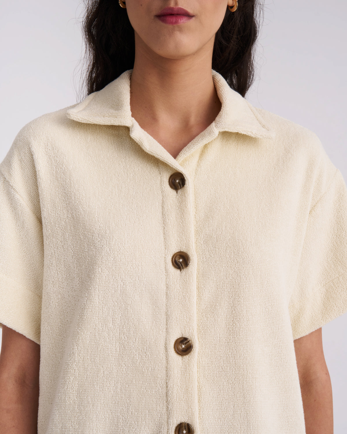 Close-up of the collar and tortoiseshell buttons on an Off-White women's terry camp-collar shirt