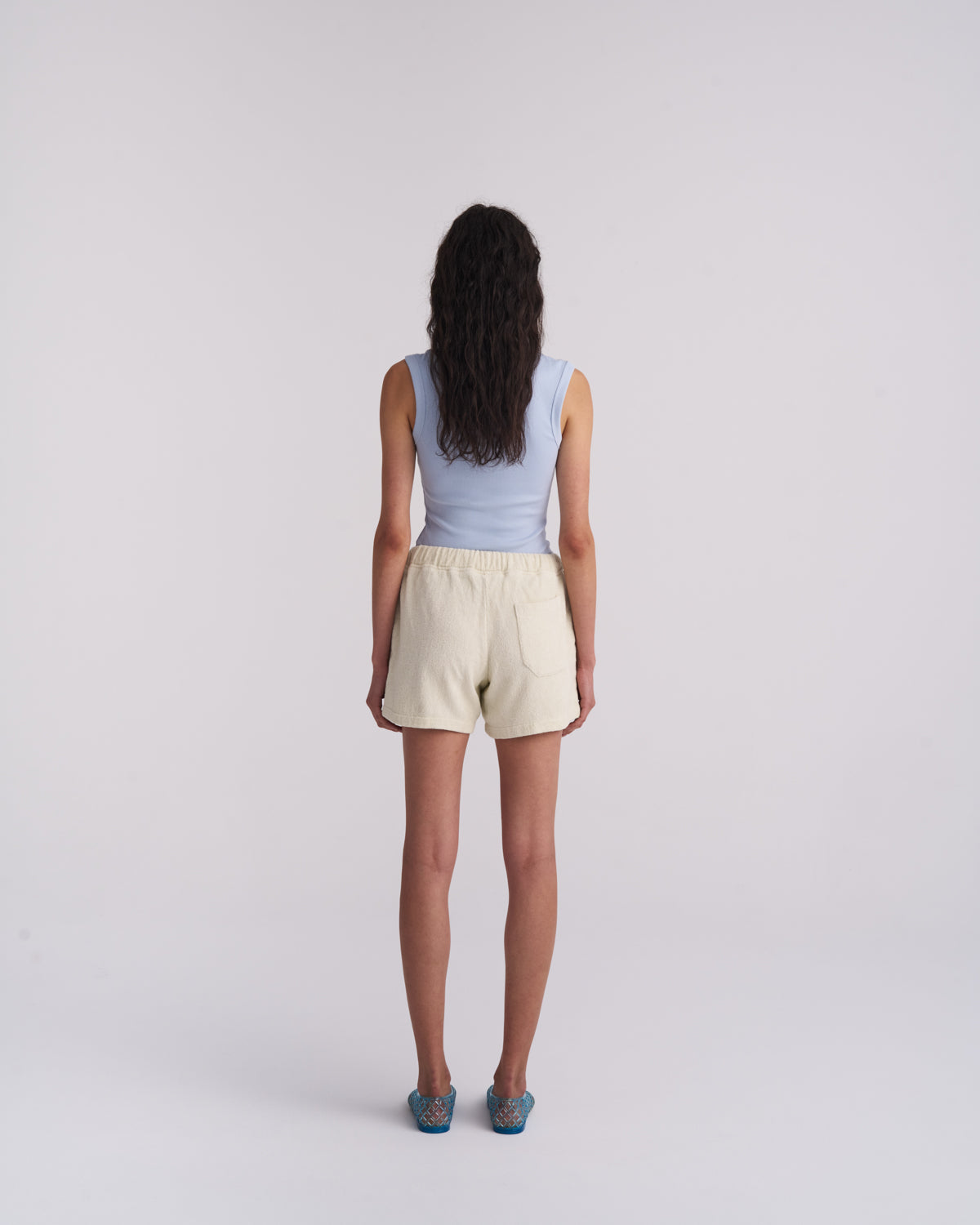 Back view of a woman wearing Off-White organic cotton terry shorts with a back pocket